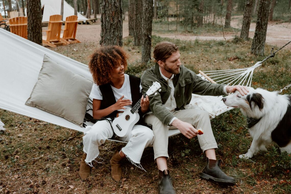 photo of a woman playing the ukulele beside a man