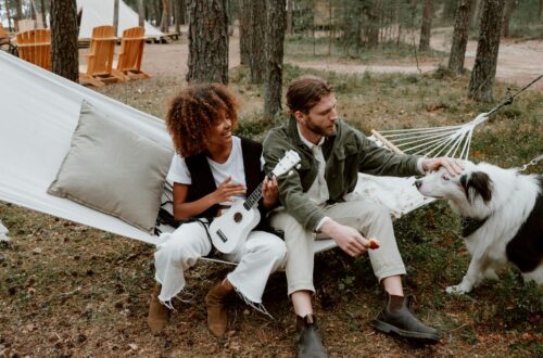 photo of a woman playing the ukulele beside a man