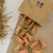 a paper bag with dog treats on a brown table